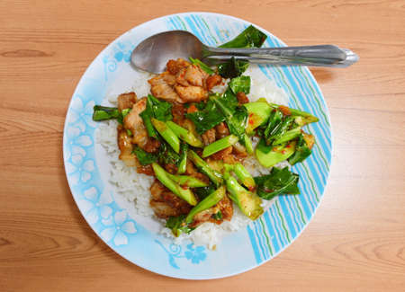 Chinese Broccoli fried with crispy pork topping on riceの写真素材