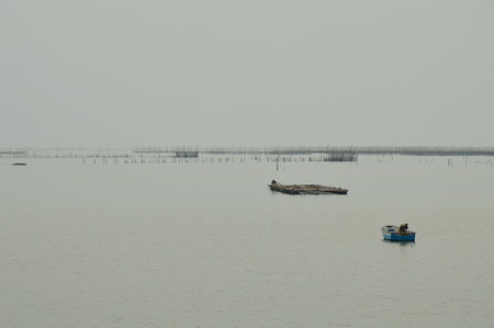 boat floating on dull seaの写真素材