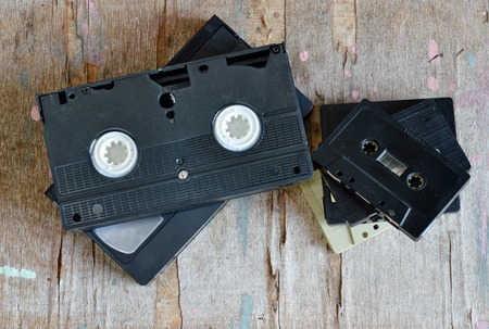cassette tape and video tape recorder on wood board