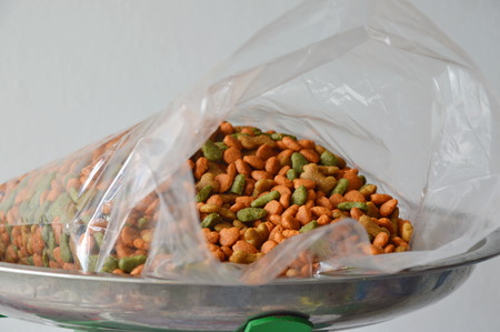 dog food in plastic bag on stainless weighting scale trayの写真素材