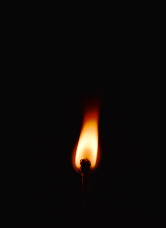 matchstick flame in the darkの写真素材