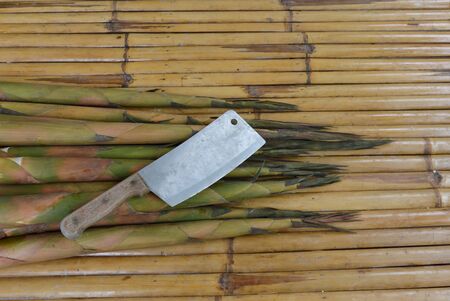 bamboo shoot and chop knife on bamboo tableの写真素材