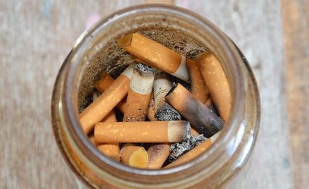 cigarette filter in glass bottleの写真素材