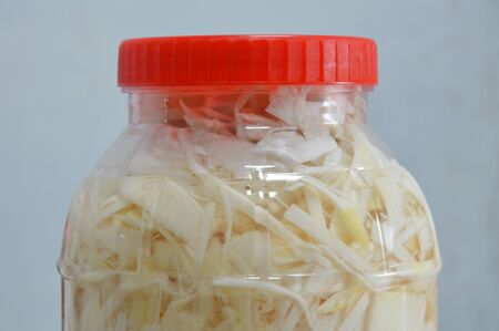 pickled slice bamboo shoot in red cap plastic bottleの写真素材