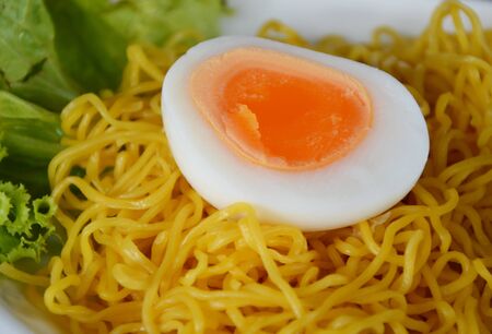 boiled egg half cut on Chinese noodleの写真素材