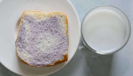 milk and bread mixed with taro on dishの写真素材