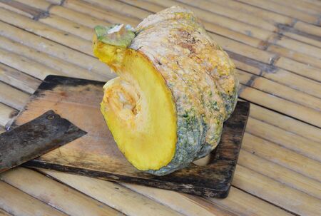 pumpkin on wooden chop block