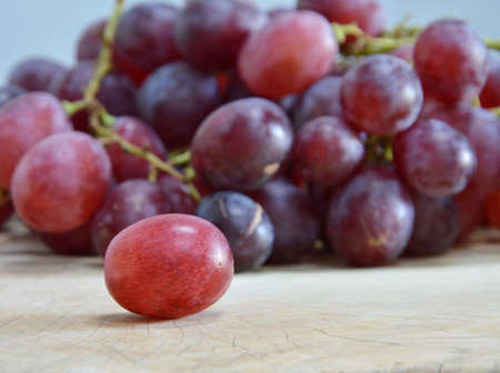 grape on wooden chop blockの写真素材