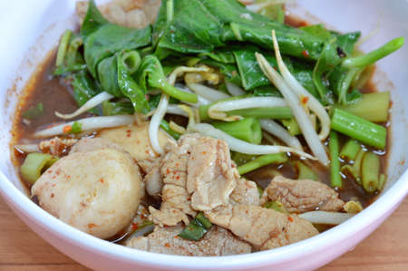 boiled slice pork in brown soup in bowl