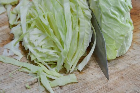 cabbage slice on wooden chop blockの写真素材