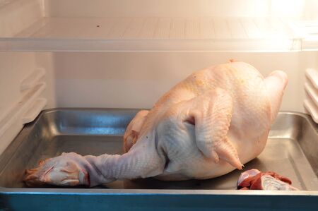 chicken on stainless tray in refrigeratorの写真素材