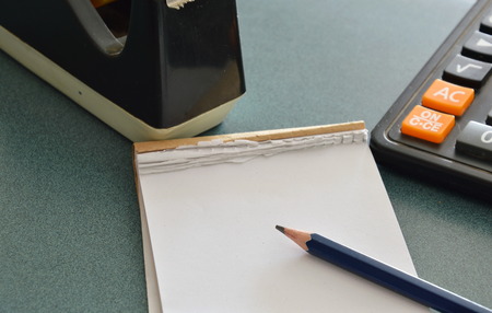paper notebook and pencil on table