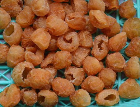 dry longan in plastic basketの写真素材