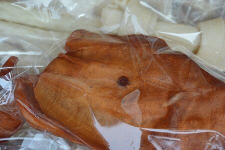 dried cow ear in plastic bag packing on basket for sale in pet shop
