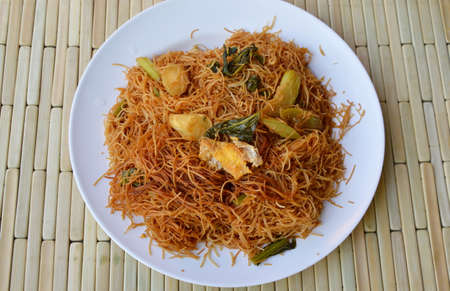 stir-fried thin rice noodle with black sweet soy sauce on dishの写真素材