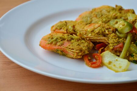 spicy stir-fried shrimp with yellow curry on plateの写真素材