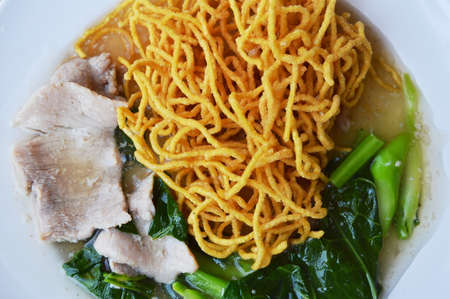 deep fried yellow noodle dressing gravy sauce on plate