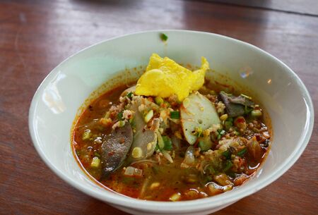 thin rice noodle with pork in spicy soup on bowl