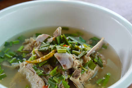 pork bone boiled in spicy and sour soup on big white bowlの写真素材