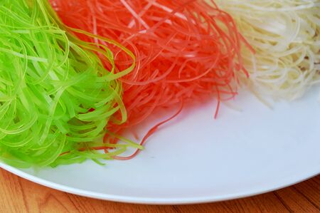 dried colorful Thai rice noodle on white plateの写真素材