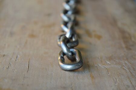 iron chain on wooden board