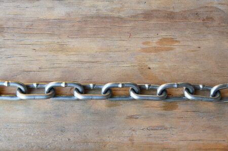 iron chain on wooden board