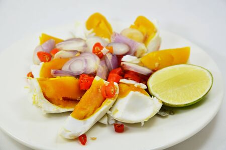 salted egg salad on dishの写真素材