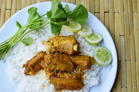 boiled red curry rib pork and vegetable on riceの写真素材