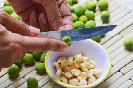 hand peel out lotus seed by kitchen knifeの写真素材