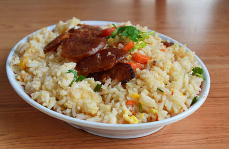 fried rice with Chinese sausage on dishの写真素材