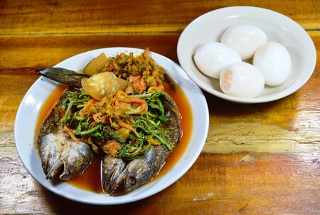 deep fried striped snake head fish in mixed hot and sour soup eat with boiled eggの写真素材