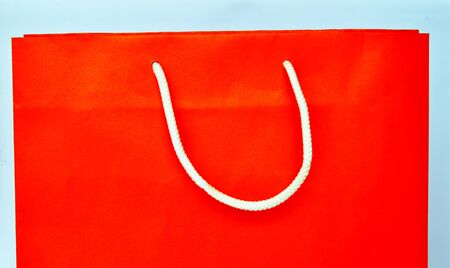 orange paper bag and white nylon rope handleの写真素材