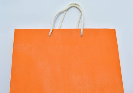 orange paper bag and white nylon rope handleの写真素材