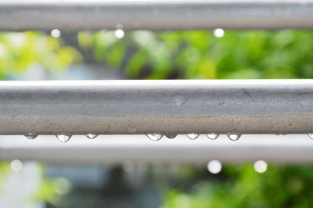 drop of water on aluminum clothes line after rainingの写真素材
