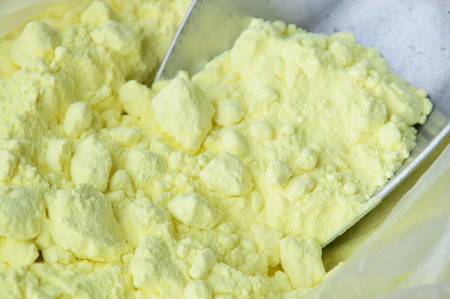 sulphur on iron scoop in plastic bagの写真素材