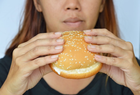 woman eating pork hamburger dressing ketchup