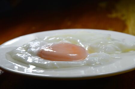 boiled egg on white dishの写真素材