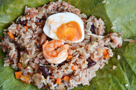 shrimp and salt egg topping on steamed rice wrapped in lotus leafの写真素材