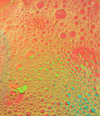oil bubble floating on water surface in color backgroundの写真素材