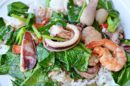 stir fried Chinese kale with seafood on riceの写真素材