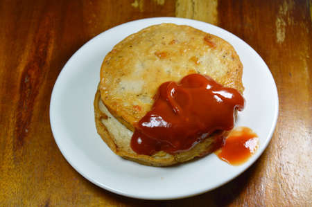 deep fried Vietnamese pork sausage dressing tomato sauce on dishの写真素材