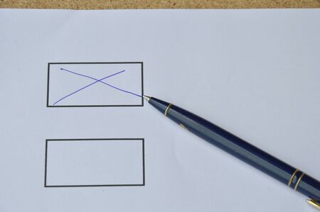 pen filled cross sign in the blank on white paperの写真素材