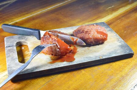 deep fried minced pork dressing ketchup slice on chopping block