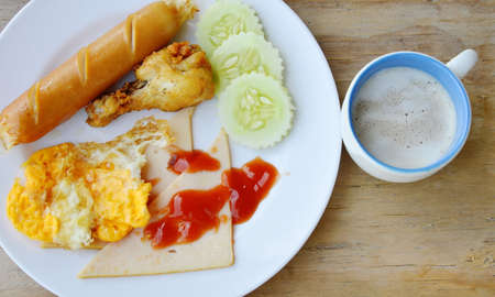 deep fried egg and sausage dressing ketchup and coffee