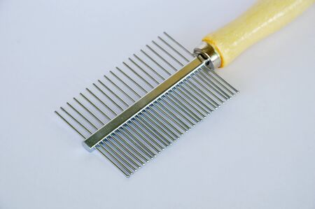 comb with teeth away and fine side for dog and cat on white background