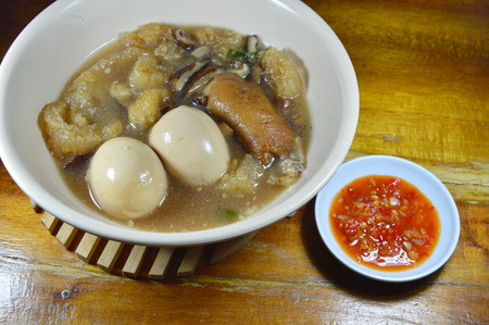 braised fish maw in red gravy topping boiled egg and spicy chili sauceの写真素材