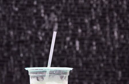 drink straw on plastic cup in water drop background