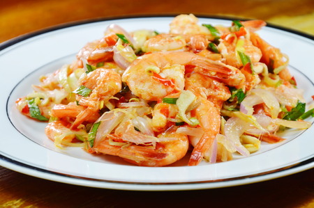 spicy prawn with herb salad on plateの写真素材
