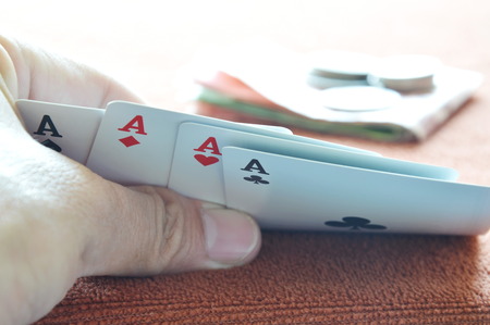 hand opened play card on table