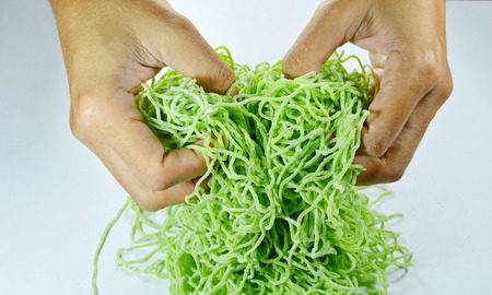 hand spread raw Chinese jade noodle prepare to cookの写真素材